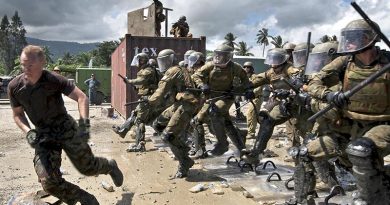 Australian soldiers break ranks and charge unruly (New Zealand soldier) protesters during a Population Protection and Control (PPC) training exercise. Photography by Leading Seaman Paul Berry.