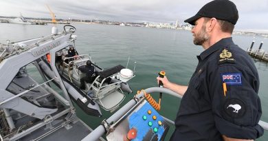 Chief Petty Officer Stephen 'Penny' Lane demonstrates the RHIB handling crane on the Royal New Zealand Navy’s new seamanship training facility at Devonport Naval Base. NZDF photo.