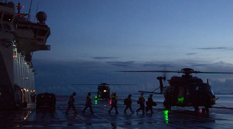 Medical teams and Solomon Island Police Force personnel board waiting MRH-90 helicopters on HMAS Adelaide to support a medical evacuation from an island near Honiara, Solomon Islands. Photo by Chief Petty Officer Damian Pawlenko.