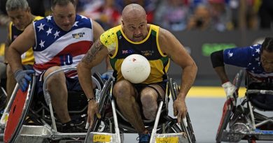 Australian Invictus team member Peter Arbuckle contests the ball during the wheelchair rugby bronze-medal play-off match against the United Stags during the Invictus Games in Toronto, Canada. Photo by Leading Seaman Jason Tufrey.