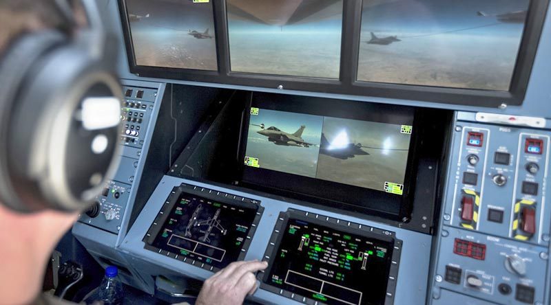 A Royal Australian Air Force air refuelling officer on the flight deck of a KC-30A Multi Role Tanker Transport controls refuelling operations for a Dassault Rafale M from the French during an Operation Okra mission over the Middle East. Photo by Corporal David Cotton.