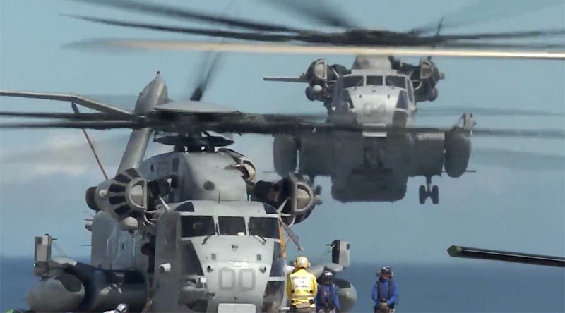 Two US Marine Corps CH-53E Super Stallions operate from HMAS Adelaide during the final amphibious assault of RIMPAC 2018. US DoD video screen grab.