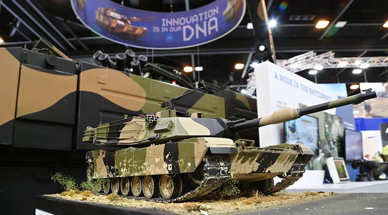 An Abram MBT model displayed in front of an Ajax Abrams-based Project LAND 400 Phase 3 contender at Land Forces 2018 in Adelaide. Photo by Brian Hartigan.