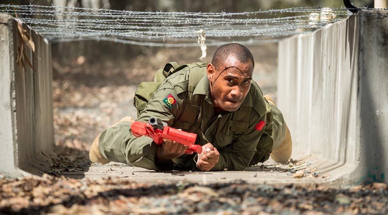 A soldier from the Republic of Fiji Military Forces crawls under an obstacle during Exercise Hydra at Enoggera Barracks in Brisbane. Photo by Corporal Nunu Campos.