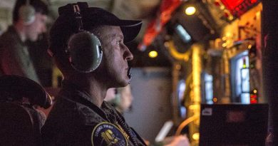 Royal Australian Air Force Warrant Officer David Bradshaw monitors a radar onboard an AP-3C Orion during a night exercise in the Philippines. Photo by Leading Seaman Jake Badior.