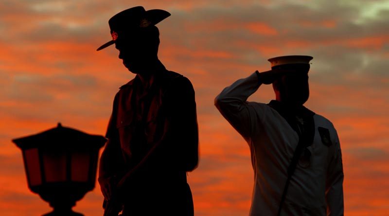 An Army Catafalque Party member rests on arms reversed as a Navy bugler salutes during an Anzac Day dawn service at Monument Hill, Fremantle, Western Australia. ADF photo.