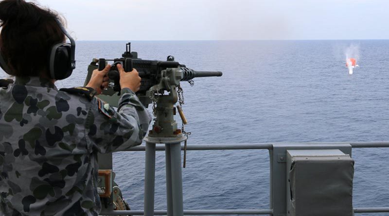 Able Seaman Stephanie Pannell engages a 'killer tomato' with a Browning M2 12.7mm machine gun on HMAS Warramunga during Exercise Bersama Lima 2016. Photo by Chief Petty Officer Martin Anderson.