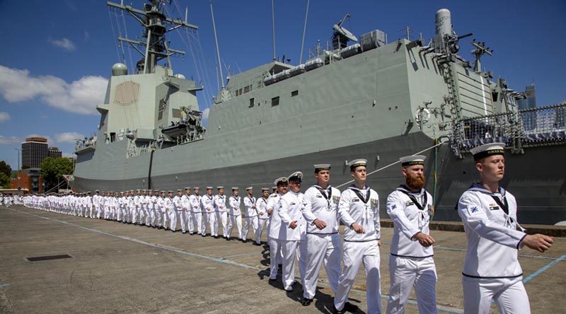 The commissioning crew of HMAS Brisbane march on to their new ship during a ceremony at Fleet Base East. Photo by Leading Seaman Nicolas Gonzalez.