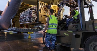 RAAF Corporal Adam Parrington guides Leading Aircraftman Madison Dukes, while loading a C-130J Hercules with humanitarian-aid supplies in Balikpapan as part of Operation Indonesia Assist 2018. Photo by Leading Seaman Jake Badior.