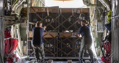 Air Warfare Officer Flight Lieutenant Adam Palmer and Air Loadmaster Corporal Toni Thompson load aid into a Royal New Zealand Air Force C-130 Hercules, for delivery Palu, at the 'air bridge' in Balikpapan airport. NZDF photo.