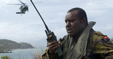 A Papua New Guinea Defence Force soldier conducts a landing-zone briefing and coordinates the extraction of military personnel by an Australian Army Black Hawk helicopter in Papua New Guinea during an exercise. Photo by Leading Seaman Justin Brown.