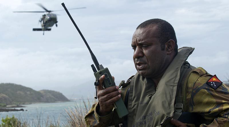 A Papua New Guinea Defence Force soldier conducts a landing-zone briefing and coordinates the extraction of military personnel by an Australian Army Black Hawk helicopter in Papua New Guinea during an exercise. Photo by Leading Seaman Justin Brown.