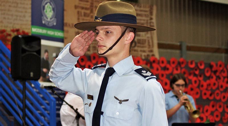 Catafalque Party Commander Cadet Flight Sergeant Tomasz Kocimski salutes during the Last Post. CFSGT Kocimski wears the General Flying Proficiency Badge – aged 17, he has qualified as a solo pilot in both powered aircraft and gliders. Photo by Flying Officer (AAFC) Paul Rosenzweig.