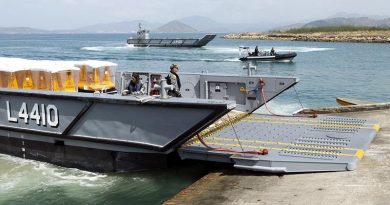 Royal Australian Navy landing craft unload marker buoys at HMPNG Basilisk Naval Base, Port Moresby, in support of APEC. Photo by Able Seaman Kieran Whiteley.