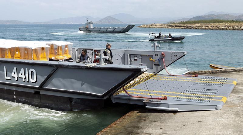 Royal Australian Navy landing craft unload marker buoys at HMPNG Basilisk Naval Base, Port Moresby, in support of APEC. Photo by Able Seaman Kieran Whiteley.