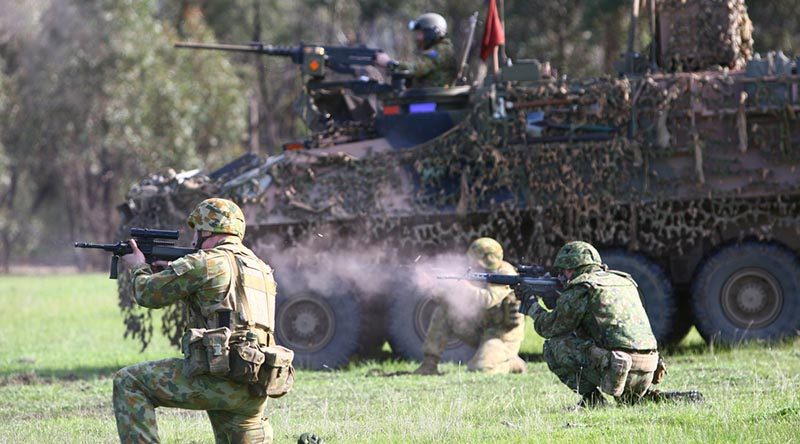 Australian, Japanese and American soldiers conduct a live-fire platoon attack with armoured fighting vehicles at Puckapunyal during Exercise Southern Jackaroo 2014. Photo by Sergeant Brian Hartigan.