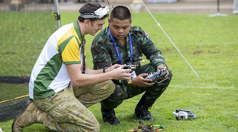 Australian Army soldier Lance Corporal Cameron Webster shows Royal Thai Army soldier Corporal Metha Yupanit how his drone works during the International Drone Racing Tournament at Victoria Barracks, Sydney. Photo by Able Seaman Tara Byrne.