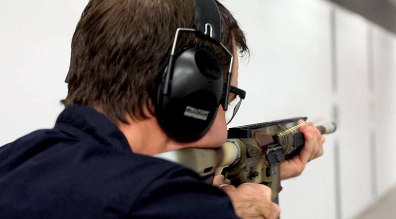 A NIOA employee goes full auto with a Colt M4A1-AU on the range to test the durability of EC Paint under extreme conditions. NIOA photo.