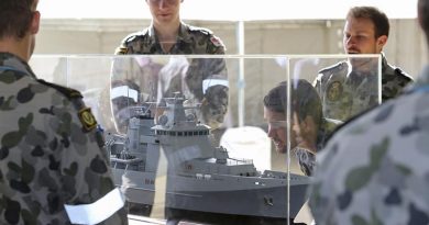 Sailors from the Royal Australian Navy Construction Branch inspect a model of an Arafura-class offshore patrol vessel at Osborne Naval Shipyard in Adelaide. Photo by Lieutenant Ryan Zerbe.