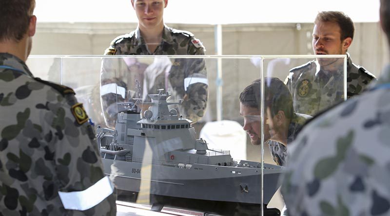 Sailors from the Royal Australian Navy Construction Branch inspect a model of an Arafura-class offshore patrol vessel at Osborne Naval Shipyard in Adelaide. Photo by Lieutenant Ryan Zerbe.
