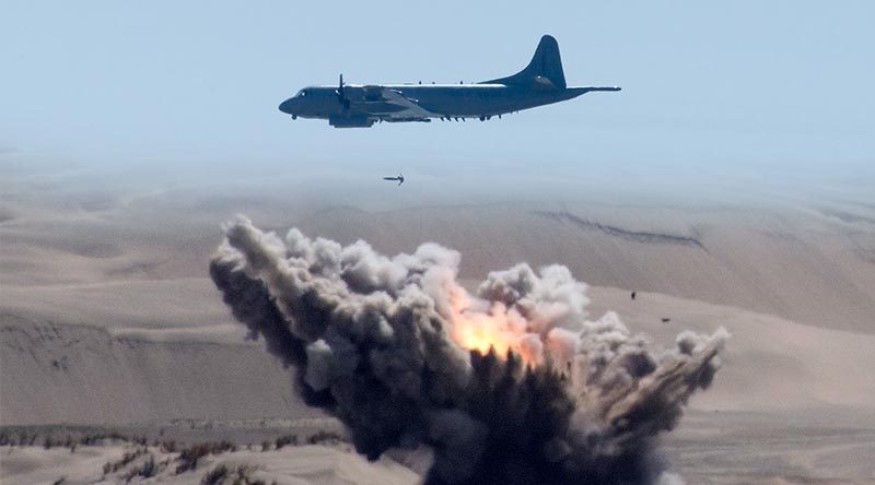 A Royal New Zealand Air Force P-3K2 drops a bomb on Kaipara Air Weapons Range. Two NZDF images merged by CONTACT.