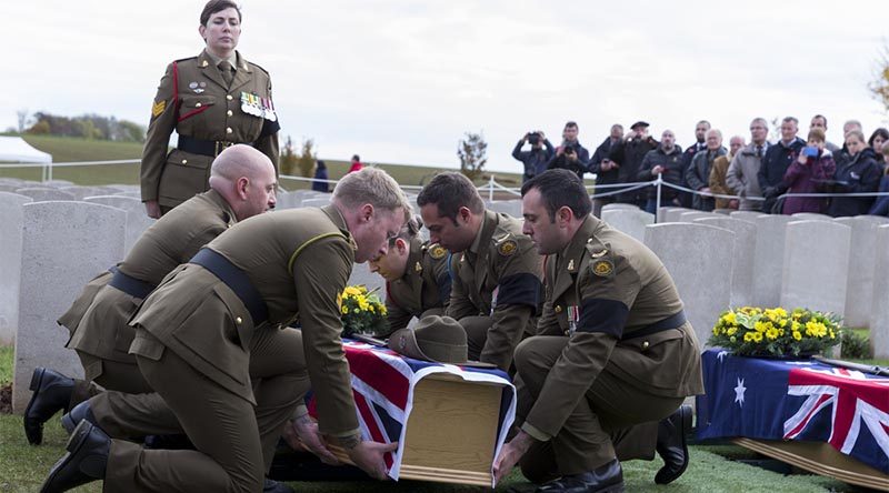 Australian Army pallbearers lower the coffin of a recently identified Australian soldier to his final resting place, at Queant Road Cemetery, France, more than 100 years after he was killed in action on the Western Front. Photo by Leading Seaman Nadav Harel.