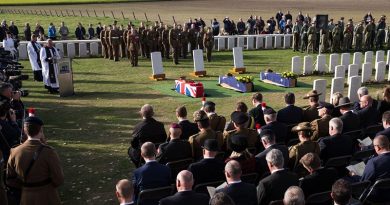 The caskets of unknown First World War Australian and British soldiers lie next to their headstones, during a burial ceremony at Tyne Cot Cemetery, Belgium. Photo by Corporal Jake Sims.