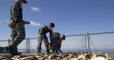 Members of HMAS Ballarat’s boarding party lay out seized narcotics in preparation for disposal in the Middle East. Photo by Leading Seaman Bradley Darvill.