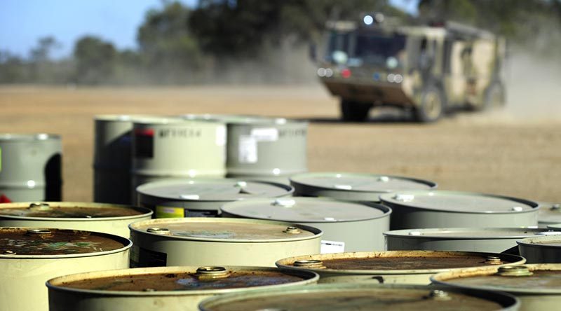 A RAAF Titan fire rescue vehicle responds to a practise fuel drum fire. Photo by Corporal Raymond Vance.