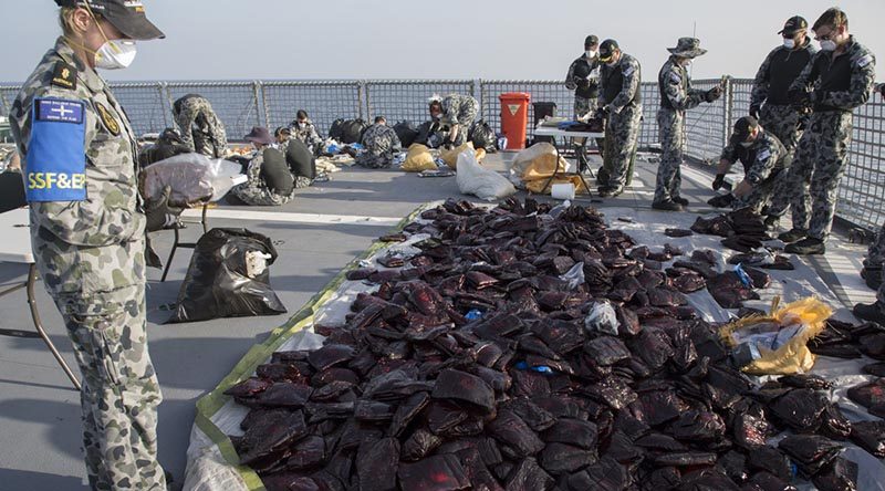 HMAS Ballarat’s boarding party and crew prepare 3.1 tonnes of seized hashish for disposal during the ship's deployment on Operation Manitou. Photo by Leading Seaman Bradley Darvill.