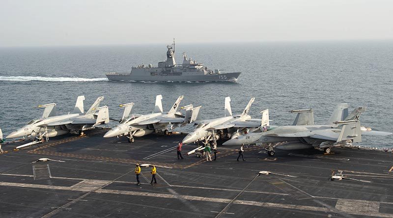 The Royal Australian Navy frigate HMAS Ballarat (FFH 155) sails alongside the aircraft carrier USS John C. Stennis (CVN 74) in the Arabian Gulf, Jan. 16, 2019, during exercise Intrepid Sentinel. Intrepid Sentinel brings together the John C. Stennis Strike Group, France’s Marine Nationale, United Kingdom’s Royal Navy and the Royal Australian Navy for a multinational exercise designed to enhance war fighting readiness and interoperability between allies and partners. The John C. Stennis Strike Group is deployed to the U.S. 5th Fleet area of operations in support of naval operations to ensure maritime stability and security in the Central Region, connecting the Mediterranean and the Pacific through the western Indian Ocean and three strategic choke points. (U.S. Navy photo by Mass Communication Specialist Seaman Jeffery L. Southerland)