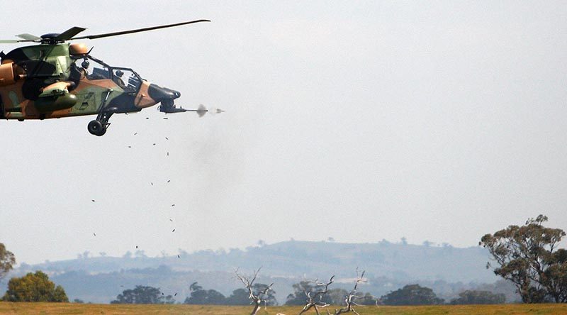 An Australian Army Tiger armed reconnaissance helicopter fires its chin-mounted chain gun during Exercise Chong Ju at the Combined Arms Training Centre at Puckapunyal, Victoria. Photo by Sergeant Brian Hartigan.