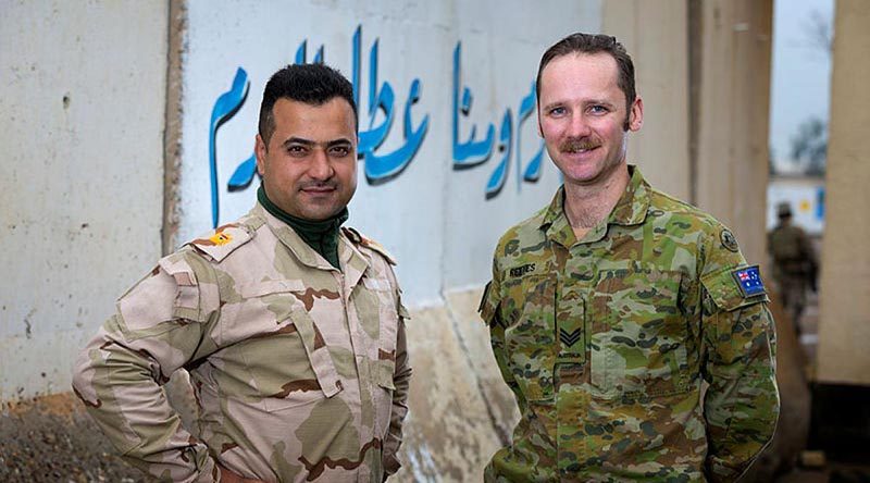 Australian Army linguist Sergeant Mitchel Reeves with Iraqi Army Major Humam at the Taji Military Complex in Iraq. Photo by Corporal Oliver Carter.