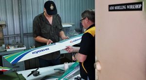 Leading Cadet Connor Bonham (608 Squadron, Gawler) receives guidance on repairing and cleaning a radio-controlled fixed-wing aircraft (a Kyoshu Calmato high wing trainer with a 60-size engine) from Sergeant (AAFC) Shayne O’Hara. Photo by Flying Officer (AAFC) Paul Rosenzweig