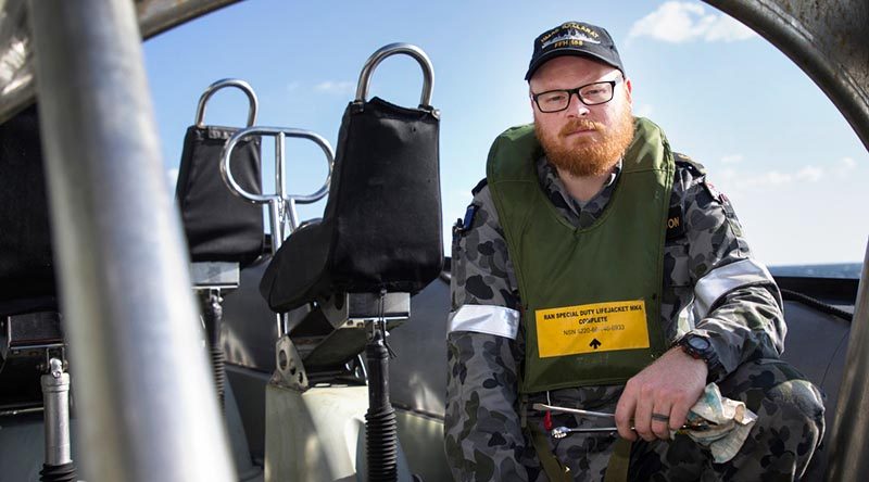Leading Seaman Daniel Jackson maintains the ship's sea boats as part of his regular duties on board HMAS Ballarat, but has secondary duties that see him employed as a drug-buster. Photo by Leading Seaman Bradley Darvill.