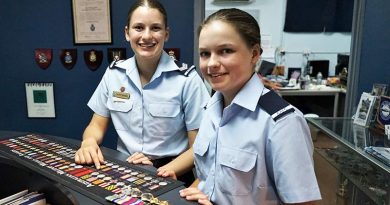 Cadet Sergeant Lucy Tassell and Cadet Charlotte Tassell with the World War 2 medals of their great-grandfather, Leading Aircraftman Owen Forrest, RAAF.