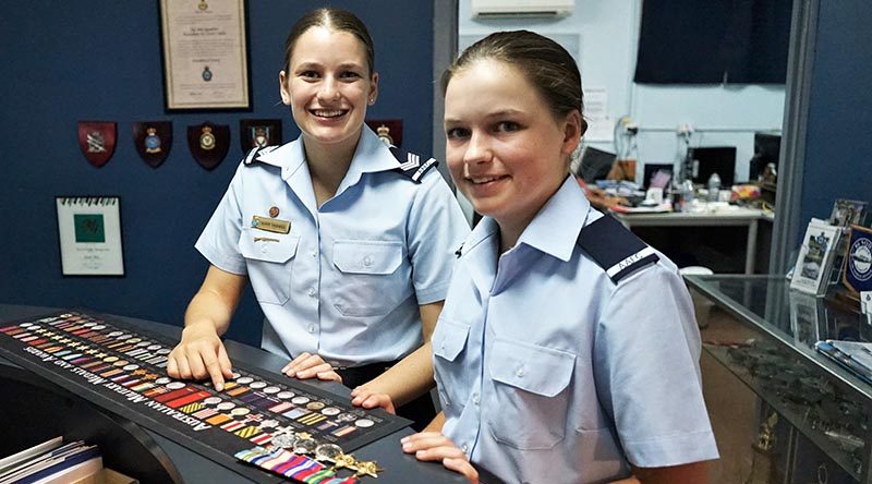 Cadet Sergeant Lucy Tassell and Cadet Charlotte Tassell with the World War 2 medals of their great-grandfather, Leading Aircraftman Owen Forrest, RAAF.