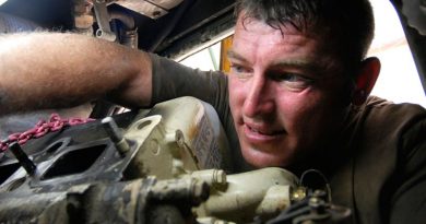 Royal Australian Electrical and Mechanical Engineer vehicle mechanic Craftsman David Butler replacing a starter motor on an Australian Light Armoured Vehicle in Iraq. Photo by Corporal Rob Nyffenegger.