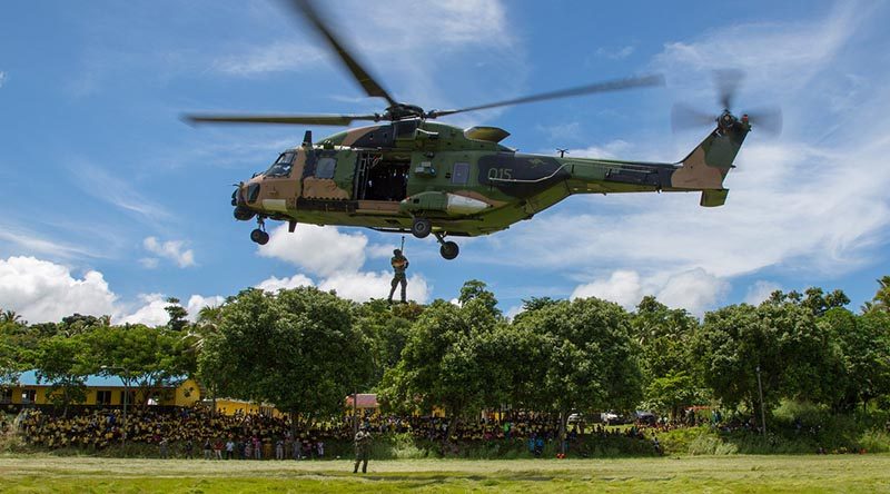 An MRH-90 helicopter from HMAS Choules' demonstrates handling and winching drills during a visit to Vanuatu. Choules will also visit Solomon Islands during her SW-Pacific Regional Engagement deployment. Photo by Petty Officer Justin Brown.