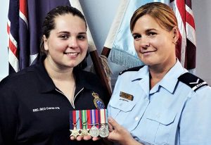 Leading Aircraftwoman (AAFC) Lisa Dibben and former Cadet Flight Sergeant Casey Dibben with the World War 2 medals of Private Geoffrey Whiteman, 6th Australian Division Workshops, AIF.