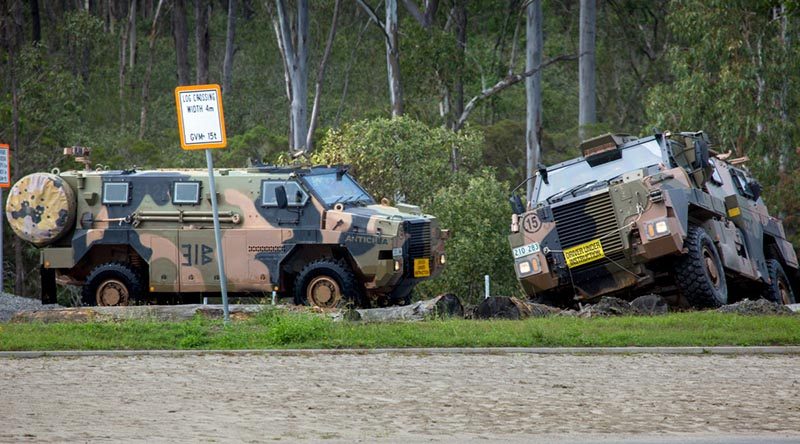 Republic of Fiji soldiers conduct Bushmaster driver training on a log-crossing obstacle, under the guidance of Australian Army driver training instructors, at Greenbank Training Area. Photo by Corporal Nicci Freeman.