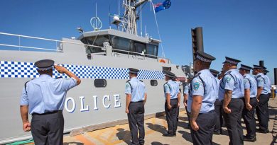 Members of the Tuvalu Police Force salute the rising of their national flag for the first time on their new Guardian-class patrol boat, gifted by Australia. Photo by Petty Officer James Whittle.