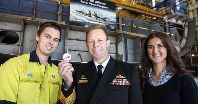 Boilermaker Kane Ramsay and Document Editor Lauren Pitman prepare to assist Chief of Navy Vice Admiral Michael Noonan to lay a traditional coin under the keel of the future HMAS Arafura. Photo supplied by ASC.