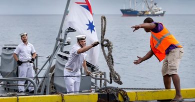 A sailor on HMAS Gascoyne throws a line to a Funafuti wharf worker as the ship pulls alongside in Tuvalu during a south-west-Pacific-engagement tour. Photo by Leading Seaman Craig Walton.