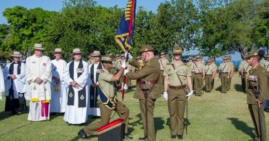 General Sir Peter Cosgrove, Governor General of Australia presents new Colours to 5RAR in Darwin, watched by Major General Mark Kelly, Colonel Commandant of The Royal Australian Regiment.