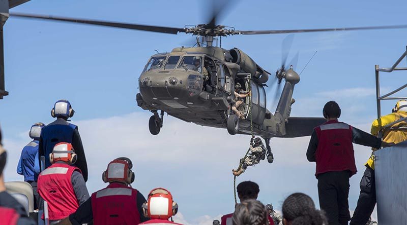 Colombian Marines fast-rope onto the flight deck of Whidbey Island-class Dock Landing Ship USS Gunston Hall during UNITAS 2018. US Navy photo by Mass Communication Specialist 3rd Class Colbey Livingston.