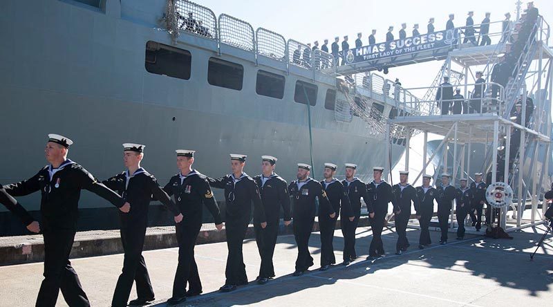 Ship’s company of HMAS Success march off the ship for the last time during her decommissioning ceremony at Fleet Base East, Sydney. Photo by Chief Petty Officer Cameron Martin.