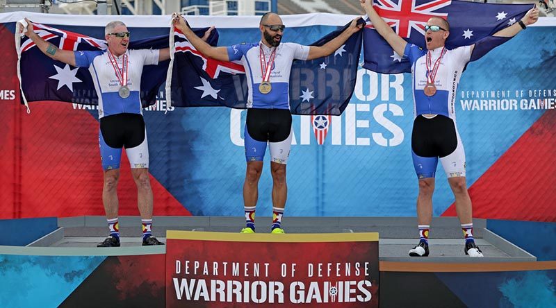 RAAF Flight Sergeant Ben Morgan (right), celebrates winning bronze in an Australian clean sweep of the cycle street race with (from left) silver medallist Jason McNulty and gold medallist Tim Grover at the Warrior Games 2018. Photo by Leading Seaman Jason Tufrey