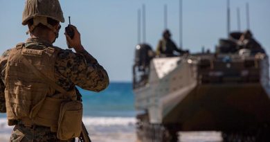 A US Marine speaks on a radio during the Combined Force Entry Operation during Exercise Talisman Sabre 19 during an amphibious landing at Stanage Bay, Queensland. US Marine Corps photo by Lance Corporal Kaleb Martin.