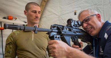 Sumit Sachdeva is briefed on the capabilities of the EF-88 rifle by Leading Aircraftman Breen Canning, from No. 3 Security Forces Squadron, during a visit to Shoalwater Bay Training Area as part of Exercise Boss Lift – Talisman Sabre 2019. Photo by Corporal Nicci Freeman.